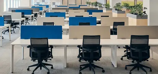 Modern open-plan office space featuring clean workstations, ergonomic chairs, and sanitized carpets provided by professional office cleaning services in Oakland, CA.