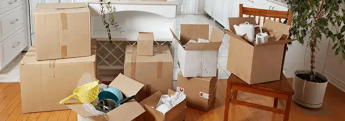 Packed moving boxes and household items in a kitchen before move-out or move-in cleaning, Oakland, CA.